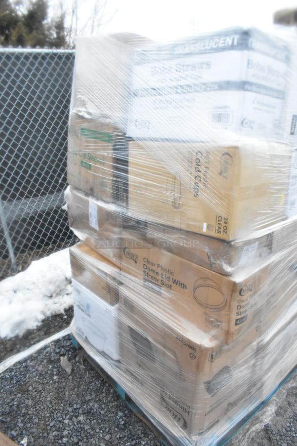 Pallet with wrapped boxes of scratch and dent items including portion cups, cold cups, and napkin bands.