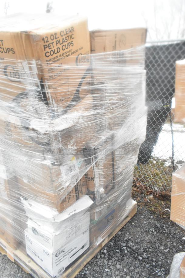 Pallet of assorted new scratch-and-dent items, including cold cups and utensils, wrapped in plastic. Boxes labeled "12 OZ. Clear PET Plastic Cold Cups" and "Heavy Weight Forks."