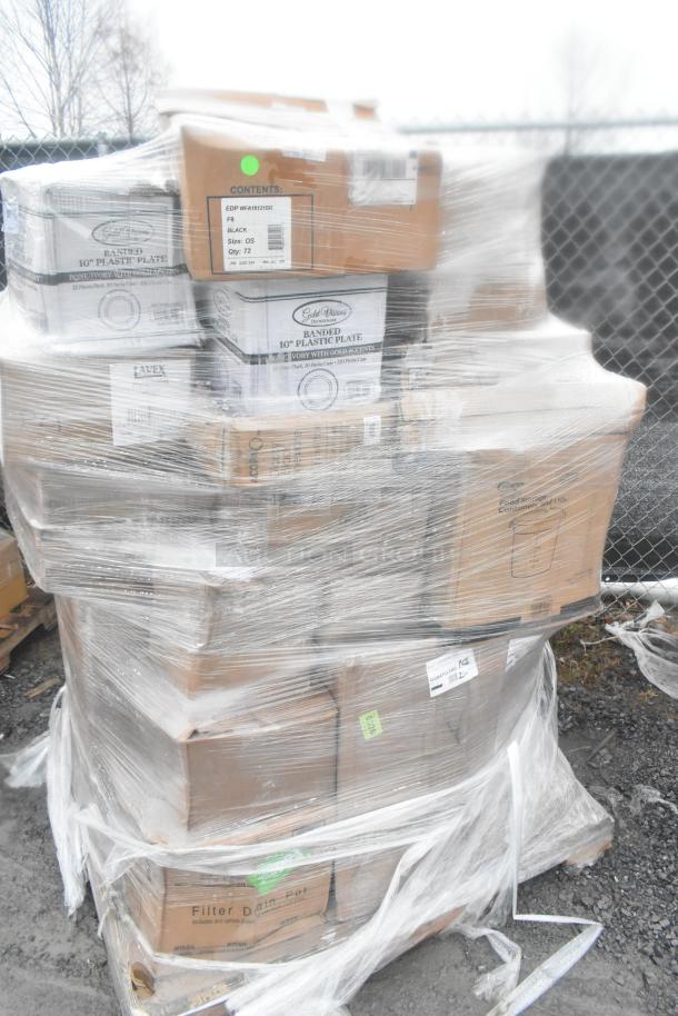 Plastic-wrapped pallet of scratch and dent items including wine glasses and jars. Boxes marked 10-inch plastic plates.