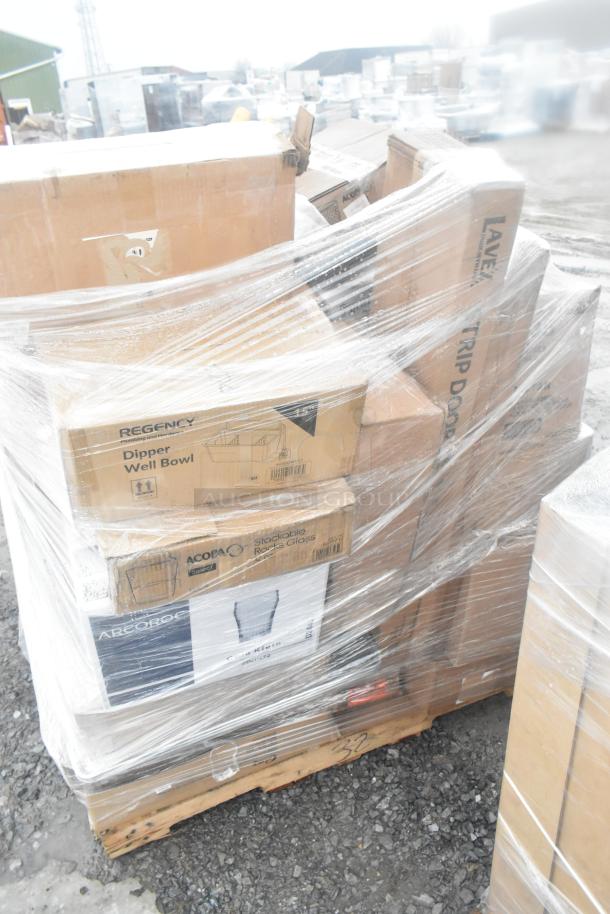 Pallet of 20 scratch-and-dent items, including boxed dolly, sieve, paper cutter, and glasses, wrapped in plastic.