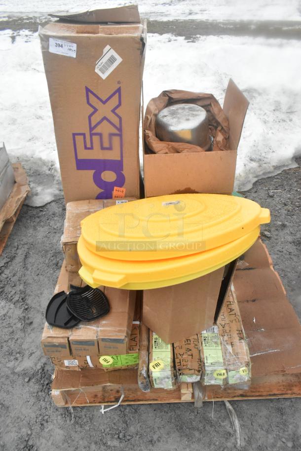 Pallet with assorted new scratch and dent items: FedEx box, yellow lid, oven rack, and packaging, outdoor setting.