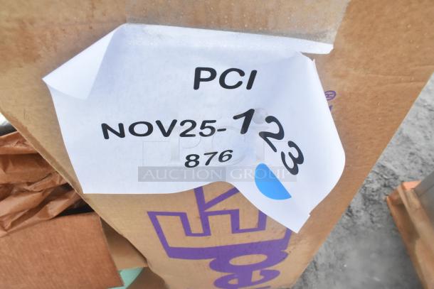 Cardboard box labeled "NOV25-123 876 PCI" containing assorted scratch and dent items including oven rack, storage rack, and more.