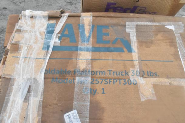 Cardboard box labeled "AVEX Foldable Platform Truck 300 lbs, Model 257SFPT300, Qty. 1." Sealed with tape.