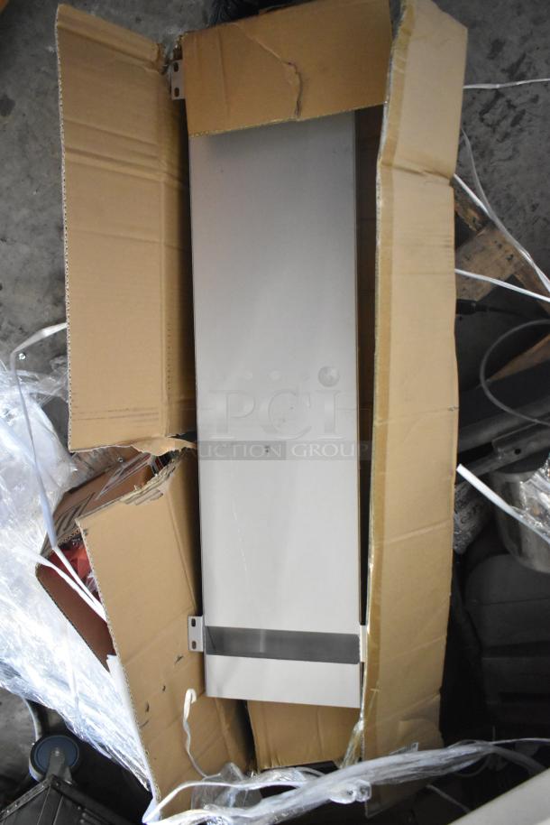 Pallet lot with metal pieces, receipt printers, and hardware in an open box, showing mixed items, fair condition.