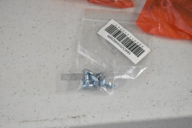 Pallet lot of various items including metal screws in bag with barcode, red bags, receipt printers, and assorted hardware.