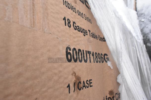 Cardboard box labeled "18 Gauge Table Under," model 600UT1896G, 1 case. Wrapped in plastic, showing warehouse scratches.
