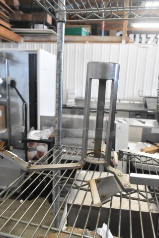 Metal auger with industrial design, solid construction, slight wear on edges, suitable for heavy-duty tasks.