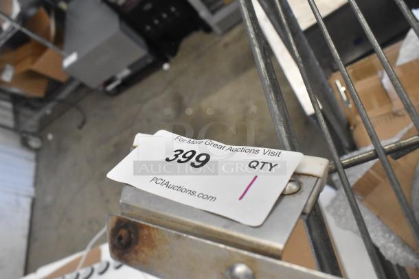 Metal auger on a shelf with a PCI Auctions tag, item 399, visible. Item condition and features not fully shown.