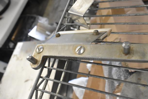 Metal auger detail showing metal screws and grille; slight rust and wear indicate used condition.