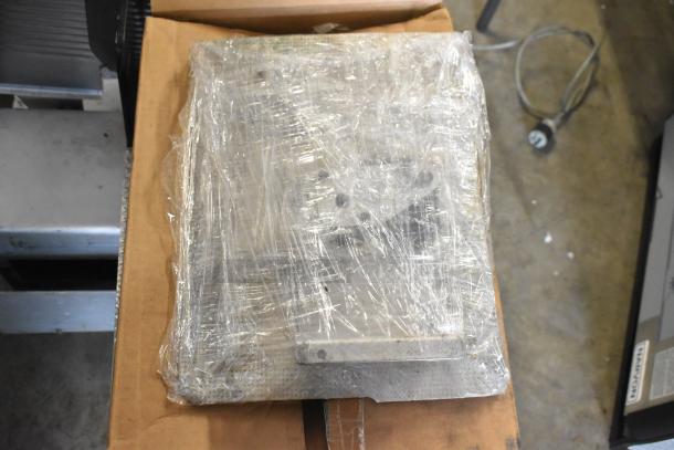 Bizerba Commercial Meat Slicer, 115 Volts, 1 Phase, wrapped in plastic with a box of parts, countertop model.