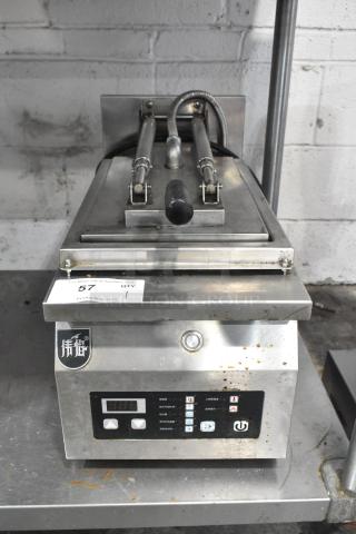 Commercial countertop electric panini press, stainless steel, 208 volts, 1 phase, digital display, good condition.