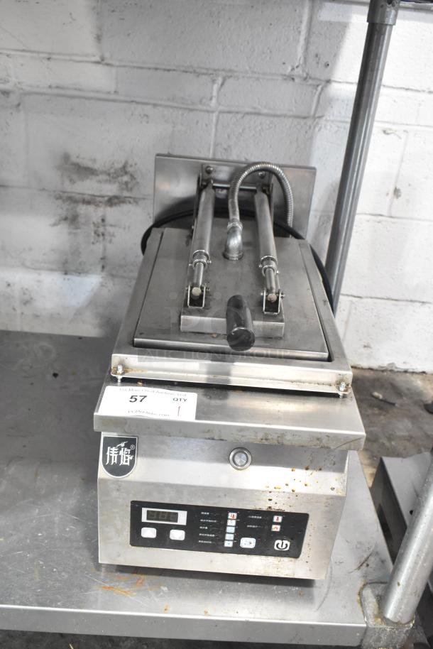 Commercial countertop electric panini press, 208V, 1 phase, stainless steel, digital controls, visible wear.