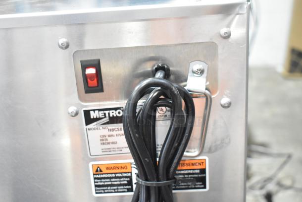Brand new Metro HBCS8-BP countertop heated cabinet, model HBCS8-BP, 120V, with simple controls, tags visible.
