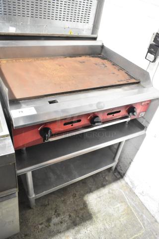 Avantco countertop flat top griddle on equipment stand, metal construction, three control knobs, used condition.