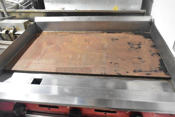 Avantco Countertop Flat Top Griddle on equipment stand, features a spacious cooking surface with signs of use and wear.