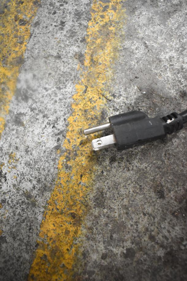 A General GEM120 planetary dough mixer, 20 quart, 110 volts, 1 phase, with attachments, is plugged in on a concrete floor.