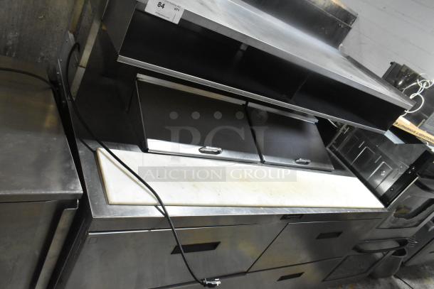 Delfield commercial sandwich prep table with four drawers, overhead shelf, and casters. 115V, 1 phase. Used condition.