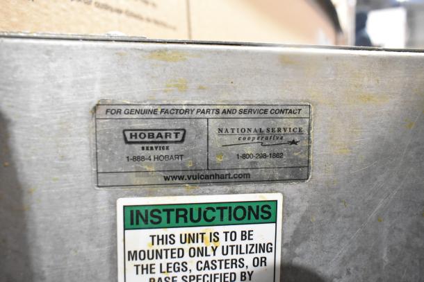 Hobart 1HF85C commercial electric fryer, 208 volts, with factory service label and mounting instructions visible.