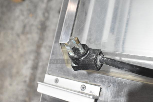 Close-up of a power plug for the Beverage Air SPE60HC-24M-CL prep table, showing slight wear on the prongs.