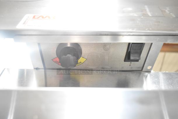 Delfield Commercial cooler control panel with temperature settings and power switch. Features casters for mobility.