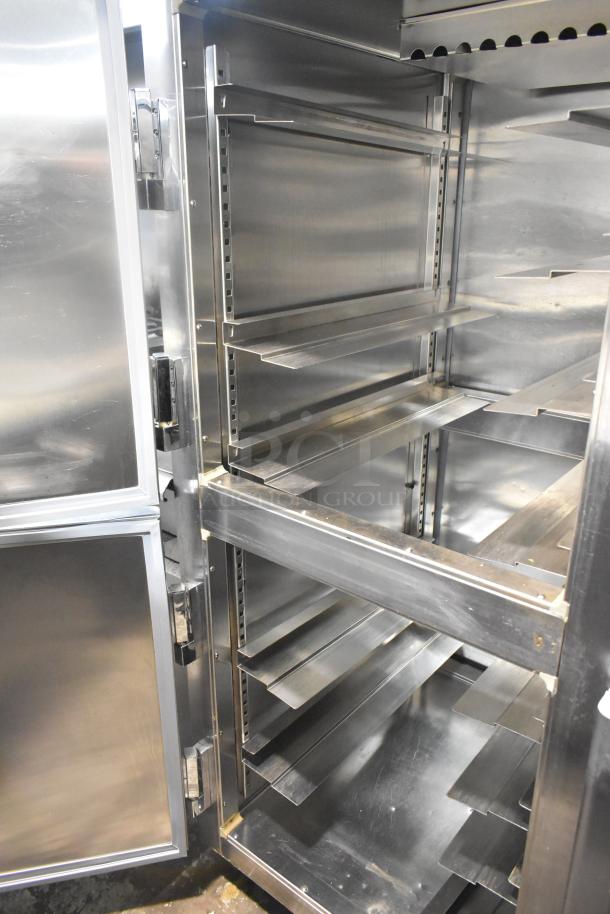 Delfield commercial 4 half-size door reach-in pass-through cooler on casters, stainless steel interior, adjustable shelves.