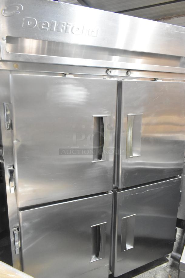 Delfield commercial pass through cooler with four half-size doors and casters. Stainless steel, good condition.