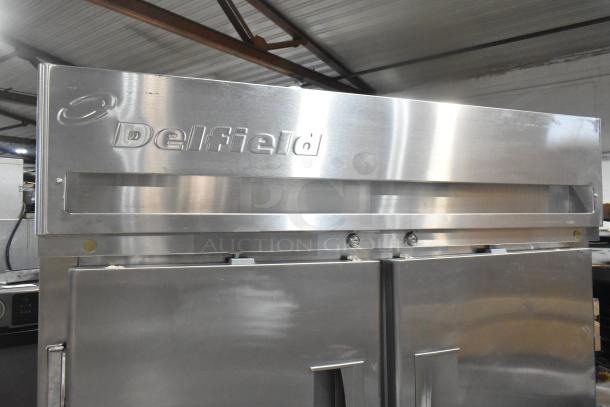 Delfield Commercial 4 Half Size Door Reach-In Pass Through Cooler, stainless steel, with logo, on commercial casters.