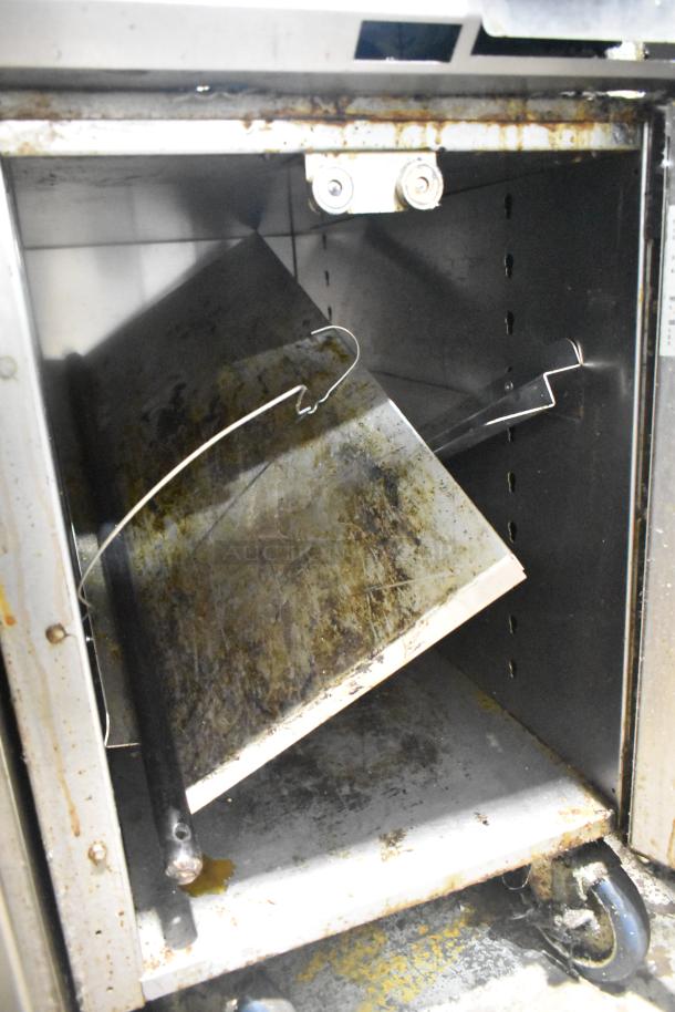 Vulcan VGM18B commercial gas griddle with lower cabinet, visible wear and rust, on blue commercial casters, 80,000 BTU.