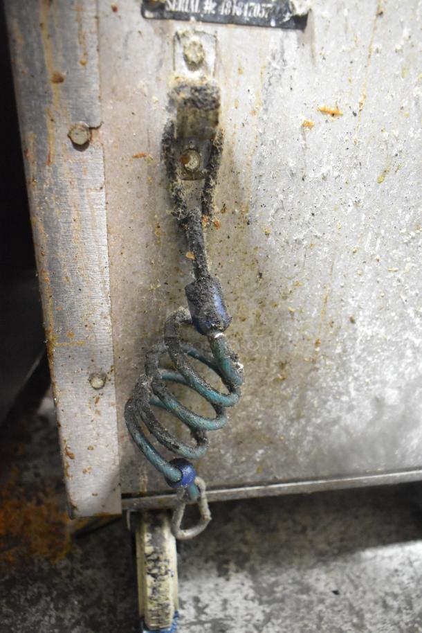 Vulcan VGM18B griddle, gas-powered, flat top, lower cabinet, commercial casters, 80,000 BTU, visible wear and dirt.