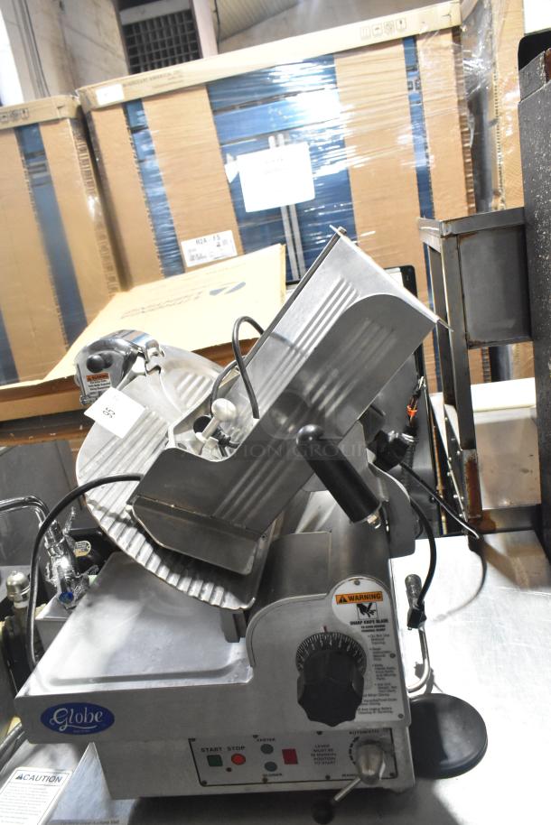 Globe 3850 Commercial Meat Slicer with blade sharpener, 115 Volts, 1 Phase, in good condition with control labels visible.