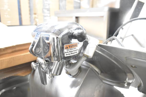 Globe 3850 commercial meat slicer with blade sharpener, stainless steel, visible warning label, 115V, 1 phase.