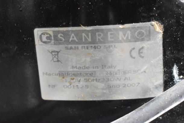 Sanremo SR50A espresso grinder label, shows make, model, voltage, and origin. Appears to have wear and some marks.