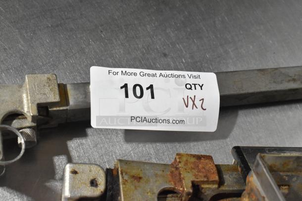 Lot of metal baking pans and pots with auction tag labeled "101" from PCI Auctions. Slight rust evident.