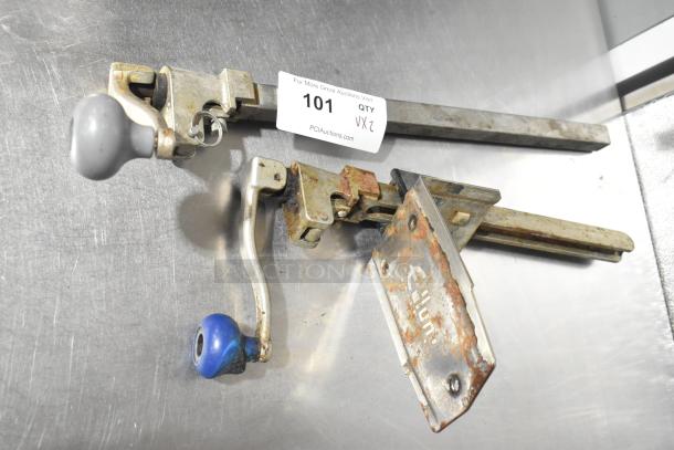 Two metal commercial can openers with one mount; visible wear and rust, includes bid tag marked "101, 2X."