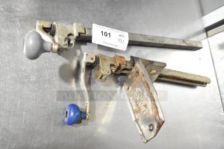 Two metal commercial can openers with one mount; visible wear and rust, includes bid tag marked "101, 2X."