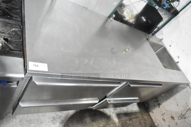 Commercial 4 Drawer Undercounter Cooler with integrated sink bay. Stainless steel, 115V, 1 phase, good condition, item tag 102.