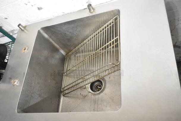 Commercial 4 Drawer Undercounter Cooler with sink bay. Features stainless steel construction, visible drainage, and wear. 115 Volts, 1 Phase.