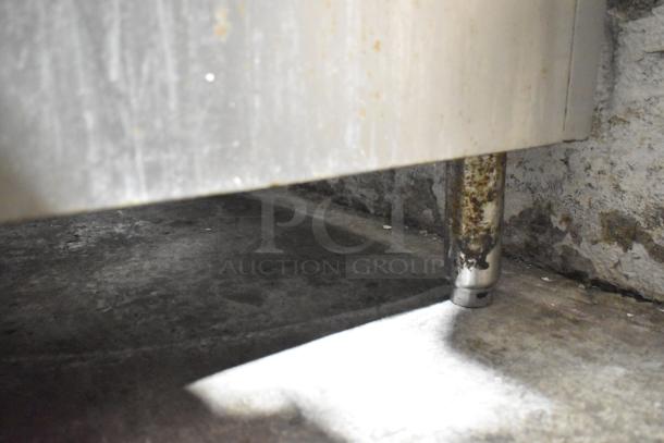 Commercial undercounter cooler leg detail, showing wear and rust on the metal surface. 115 volts, 1 phase unit.