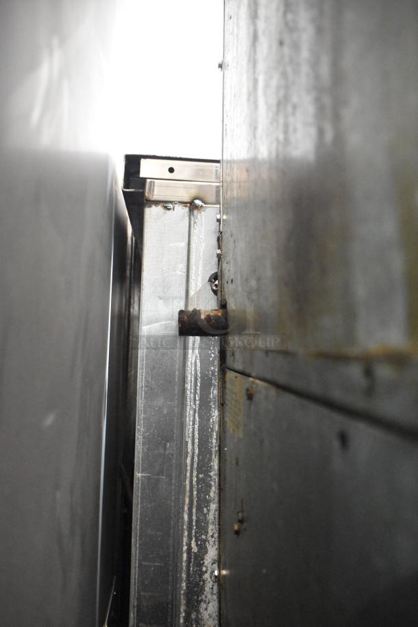 Imperial Commercial Gas Range, 6 burners, with Salamander Cheese Melter and Oven. Features visible from side angle.