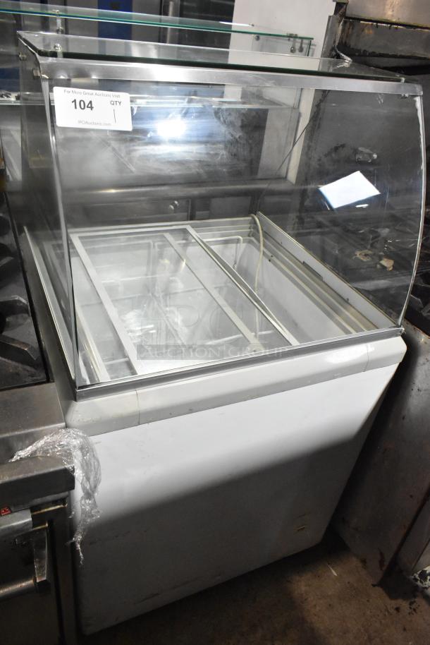 Commercial ice cream dipping cabinet, 115 volts, 1 phase. Features glass display, visible interior compartments, and good condition.