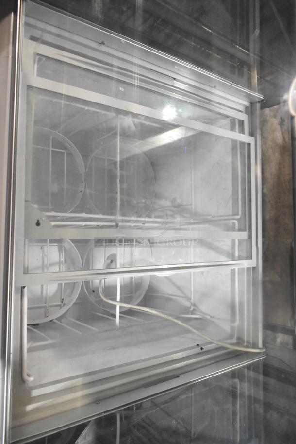 Commercial ice cream dipping cabinet, 115 volts, 1 phase. Features metal frame, glass panels, good condition.