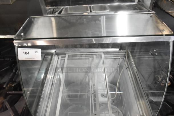 Commercial ice cream dipping cabinet, stainless steel, 115 volts, 1 phase, clear glass front, item tag 104 visible.
