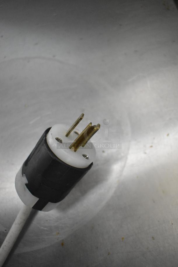 Power plug for Commercial Ice Cream Dipping Cabinet, 115 volts, 1 phase, shown on a reflective metal surface.