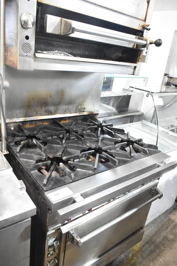 Commercial gas-powered 6 burner range with oven and salamander cheese melter. Stainless steel, used condition.