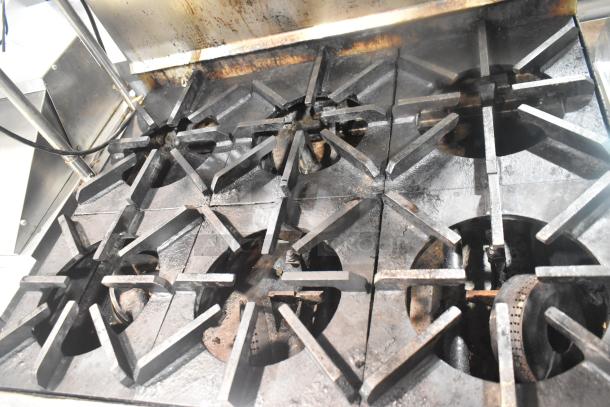 Commercial gas-powered 6 burner range with salamander cheese melter and oven, featuring robust cast iron grates.