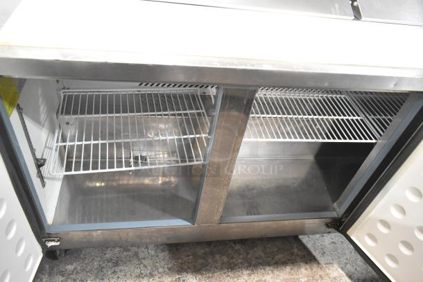 Empura KSP72 commercial prep table, stainless steel, dual shelves, on casters, 115V, 1 Phase, excellent condition.