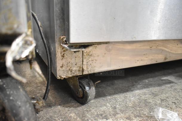 Empura KSP72 commercial sandwich prep table on casters, visible dirt and wear on wheel, 115 volts, 1 phase.