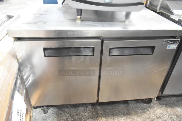 Dukers DUC48F commercial undercounter freezer with two doors, on casters. Stainless steel, 115V, 1 phase. Minor surface wear.
