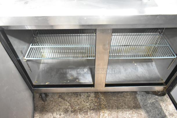 Dukers DUC48F commercial 2-door undercounter freezer on casters, stainless steel, 115 volts, 1 phase, visible interior shelves.