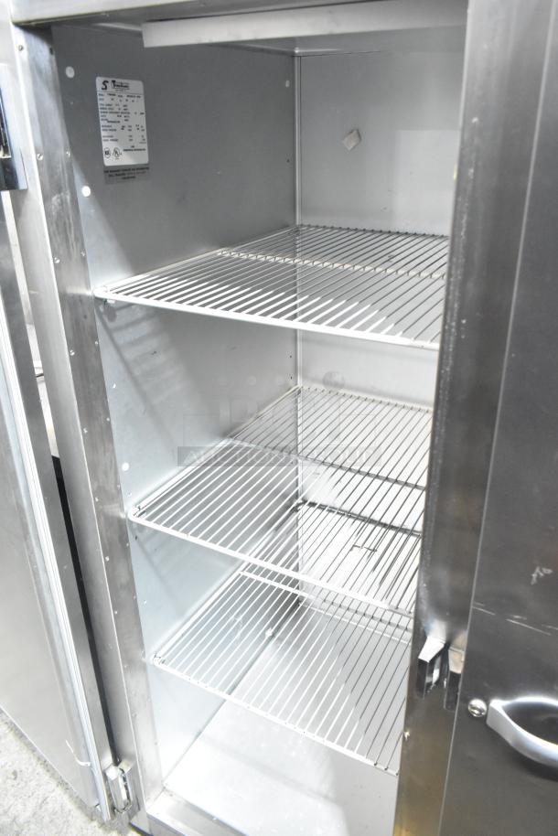 Traulsen RRI232LUT-FHS commercial 3-door reach-in freezer, stainless steel, interior racks visible, 115 volts, 1 phase.